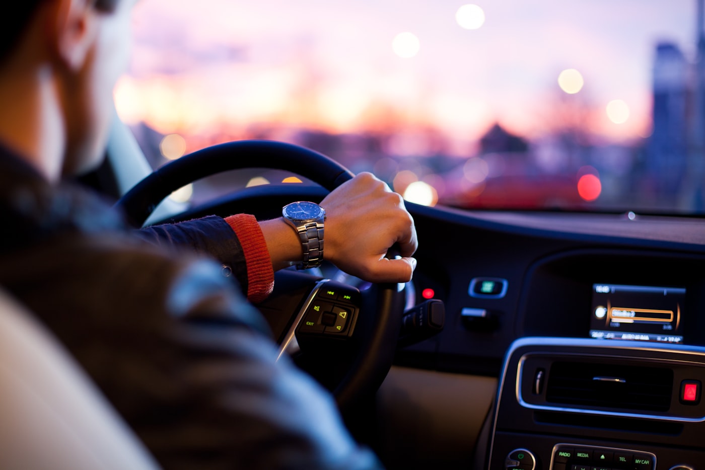 The interior of a car — dashboard, steering wheel and centre console